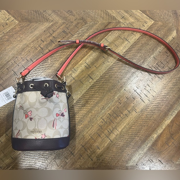 Mini Dempsey Bucket Bag In Signature Canvas With Heart And Star Print - Picture 1 of 8